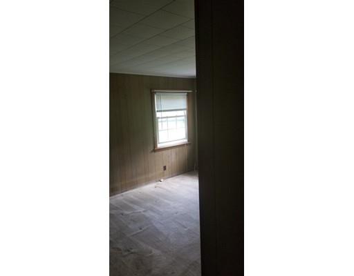 176 Rice Corner Road Brookfield, MA 01506 - Photo 8 of 18 a view of an empty room with wooden floor and a window