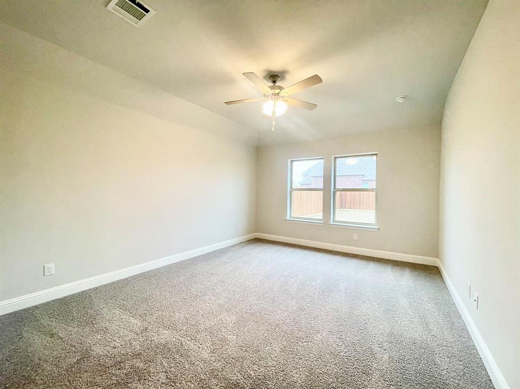 13705 Riola Drive Little Elm, TX 75068 - Photo 15 of 40 an empty room with a window and a ceiling fan