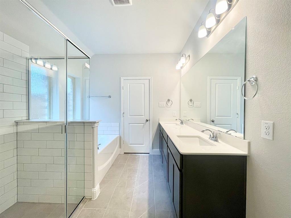13705 Riola Drive Little Elm, TX 75068 - Photo 19 of 40 a bathroom with a sink a toilet and shower