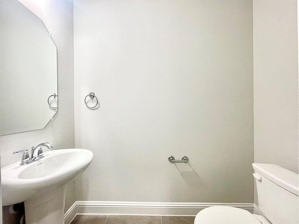 13705 Riola Drive Little Elm, TX 75068 - Photo 25 of 40 a bathroom with a sink and a mirror