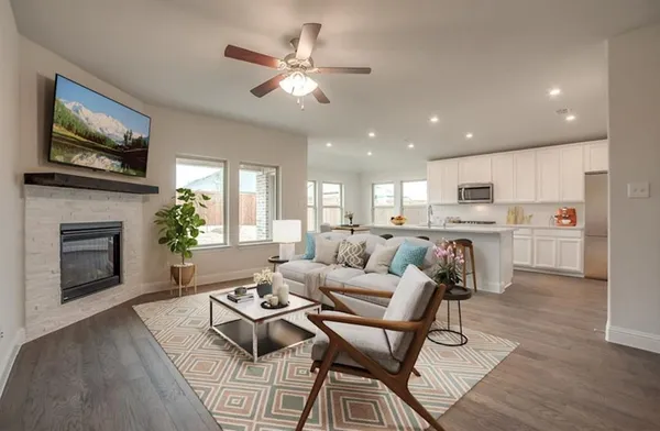 a living room with furniture a fireplace and a flat screen tv