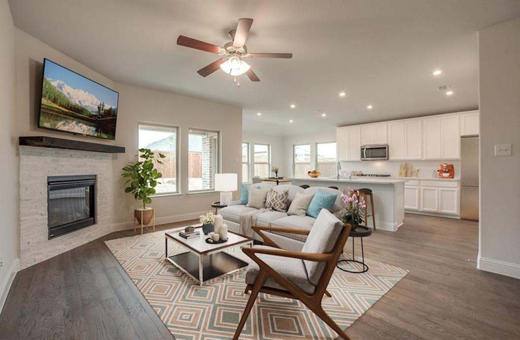 13705 Riola Drive Little Elm, TX 75068 - Photo 28 of 40 a living room with furniture a fireplace and a flat screen tv