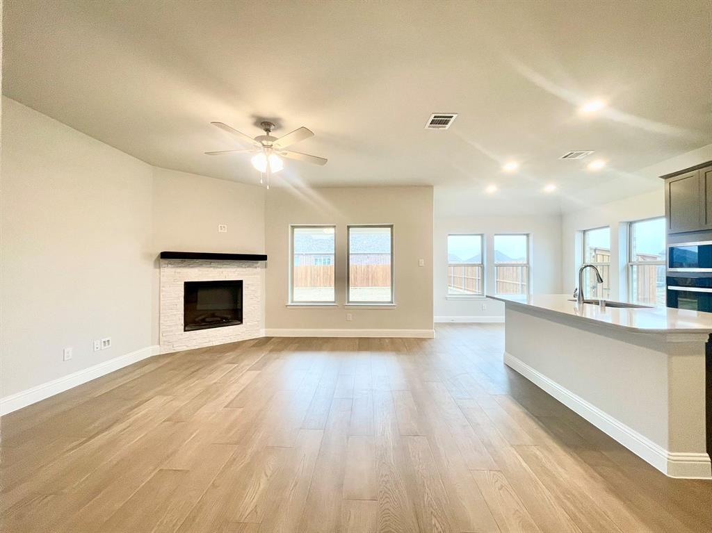 13705 Riola Drive Little Elm, TX 75068 - Photo 4 of 40 a view of an empty room with window and wooden floor