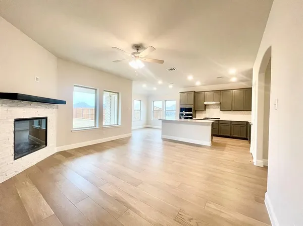 a view of a kitchen with a sink and a fireplace