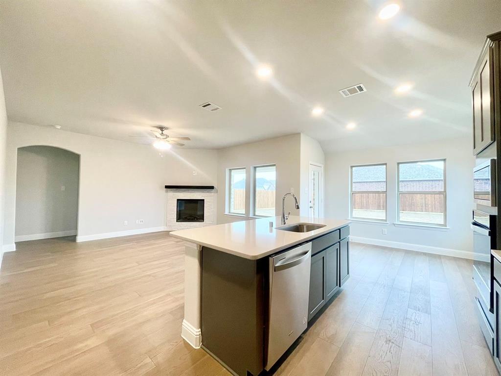 13705 Riola Drive Little Elm, TX 75068 - Photo 7 of 40 a kitchen with granite countertop a sink and a stove top oven