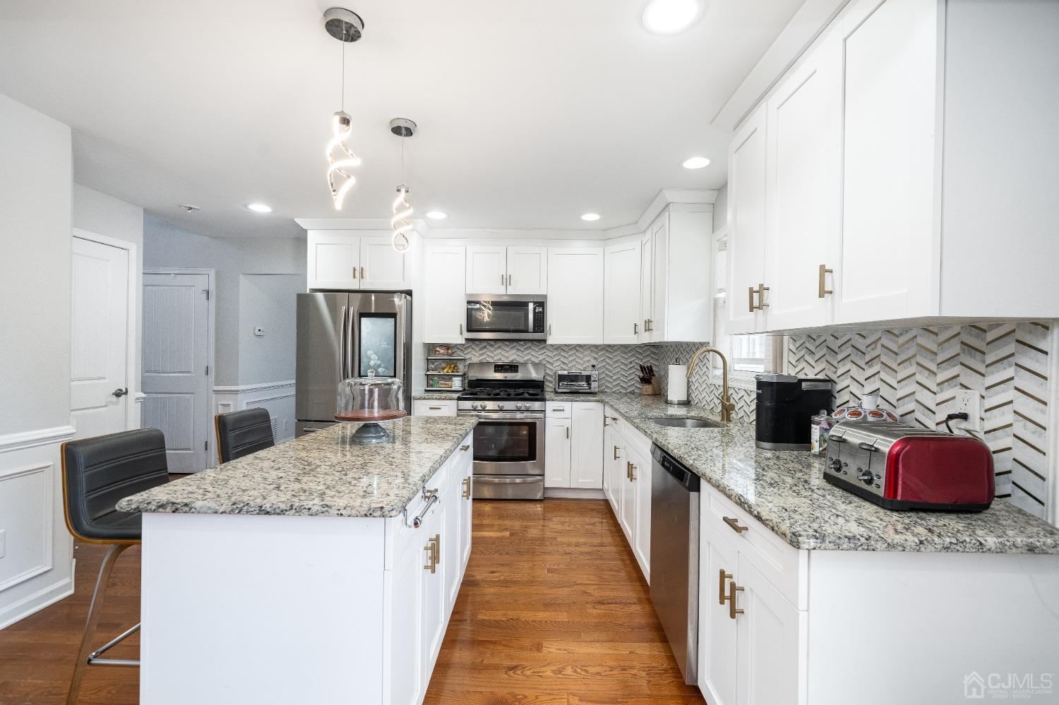 5 Glen Gary Road Middlesex, NJ 08846 - Photo 11 of 37 a kitchen with granite countertop kitchen island stainless steel appliances a refrigerator sink stove microwave and cabinets