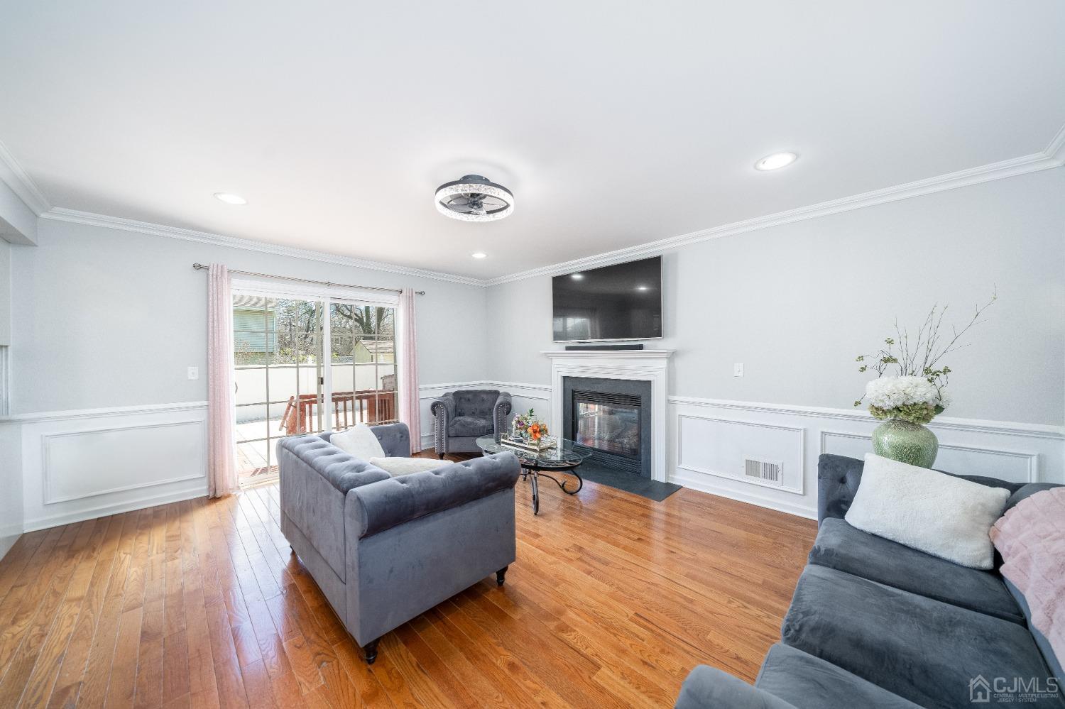 5 Glen Gary Road Middlesex, NJ 08846 - Photo 12 of 37 a living room with furniture a fireplace a flat screen tv and a large window