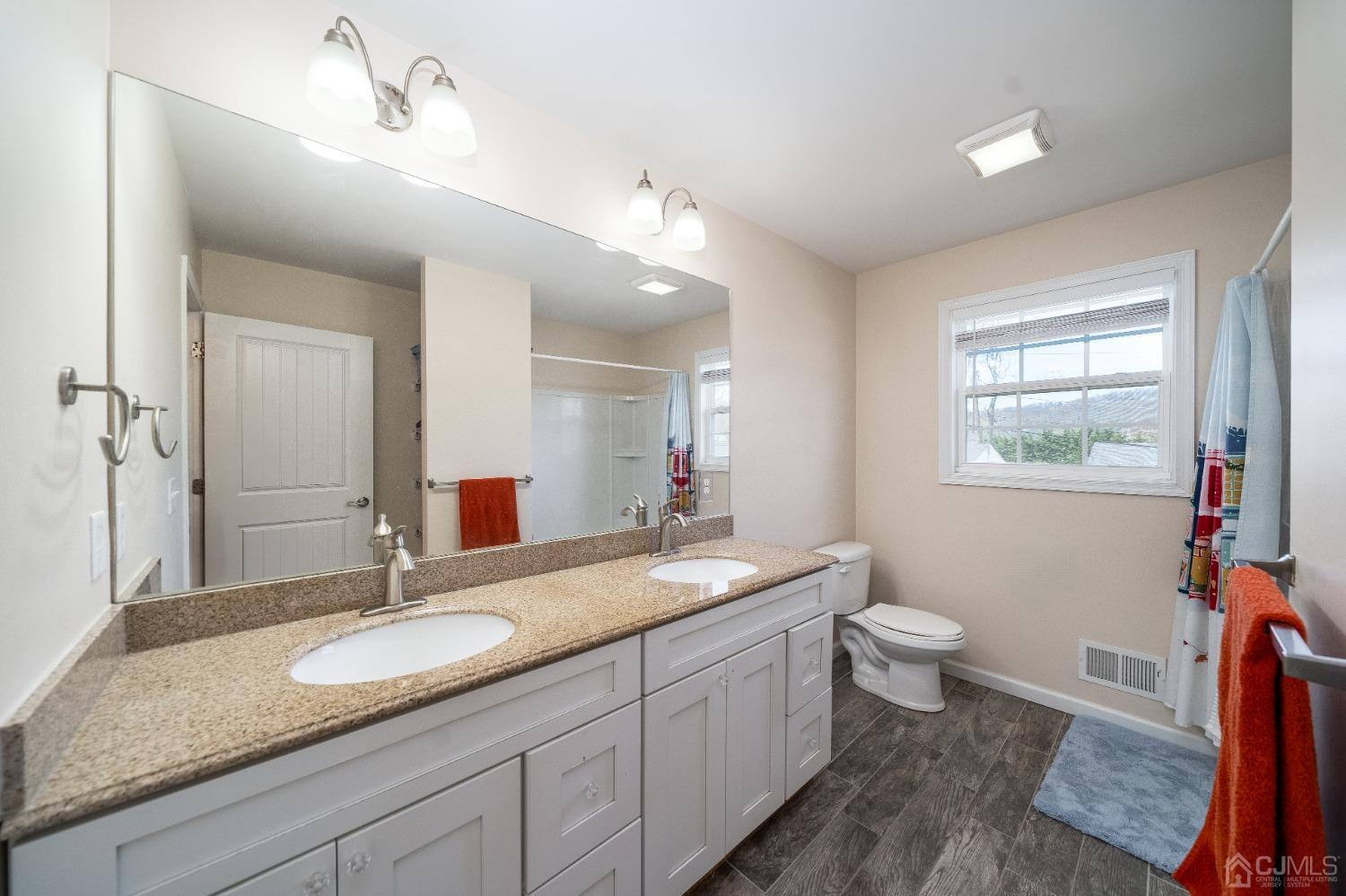 5 Glen Gary Road Middlesex, NJ 08846 - Photo 19 of 37 a bathroom with a granite countertop sink mirror vanity and toilet