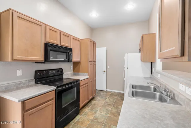 a kitchen with a stove a sink and a microwave