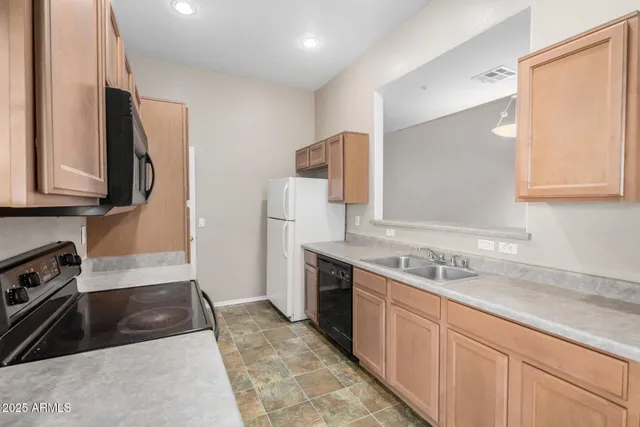 a kitchen with a sink stove and refrigerator