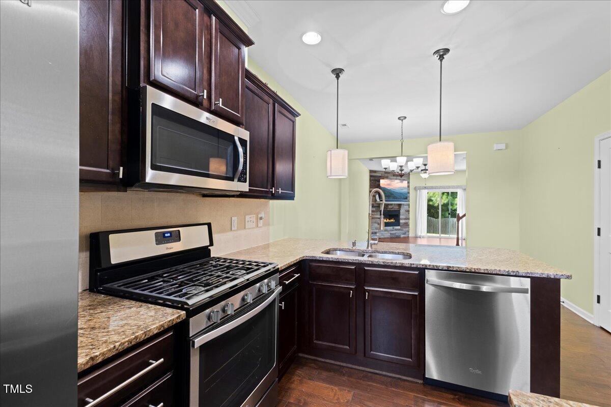 106 Churment Court Durham, NC 27703 - Photo 11 of 50 a kitchen with a sink stove and microwave