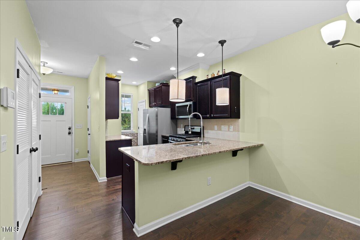 106 Churment Court Durham, NC 27703 - Photo 14 of 50 a kitchen with a sink a counter space appliances and cabinets