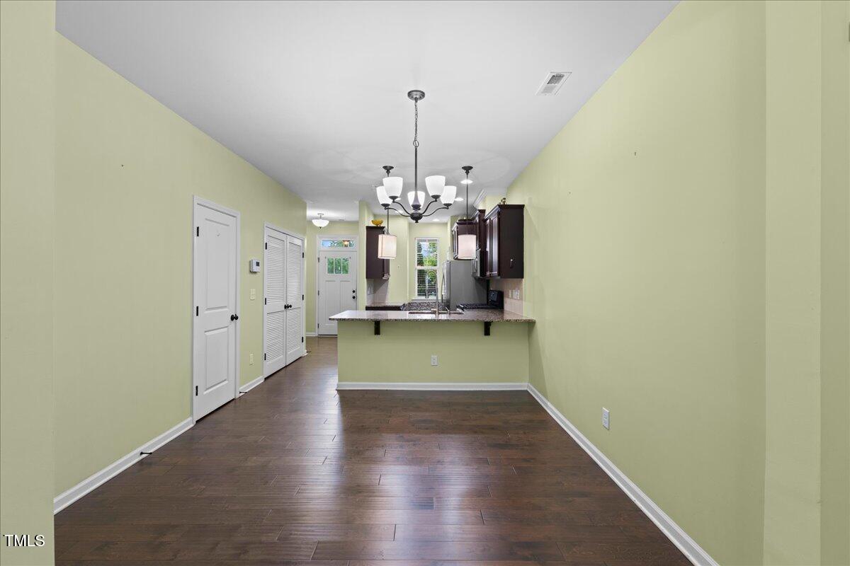 106 Churment Court Durham, NC 27703 - Photo 16 of 50 a view of a room with wooden floor chandelier and entryway