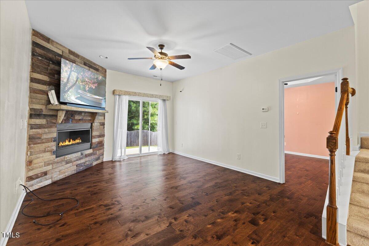 106 Churment Court Durham, NC 27703 - Photo 17 of 50 a view of an empty room with a fireplace and a window