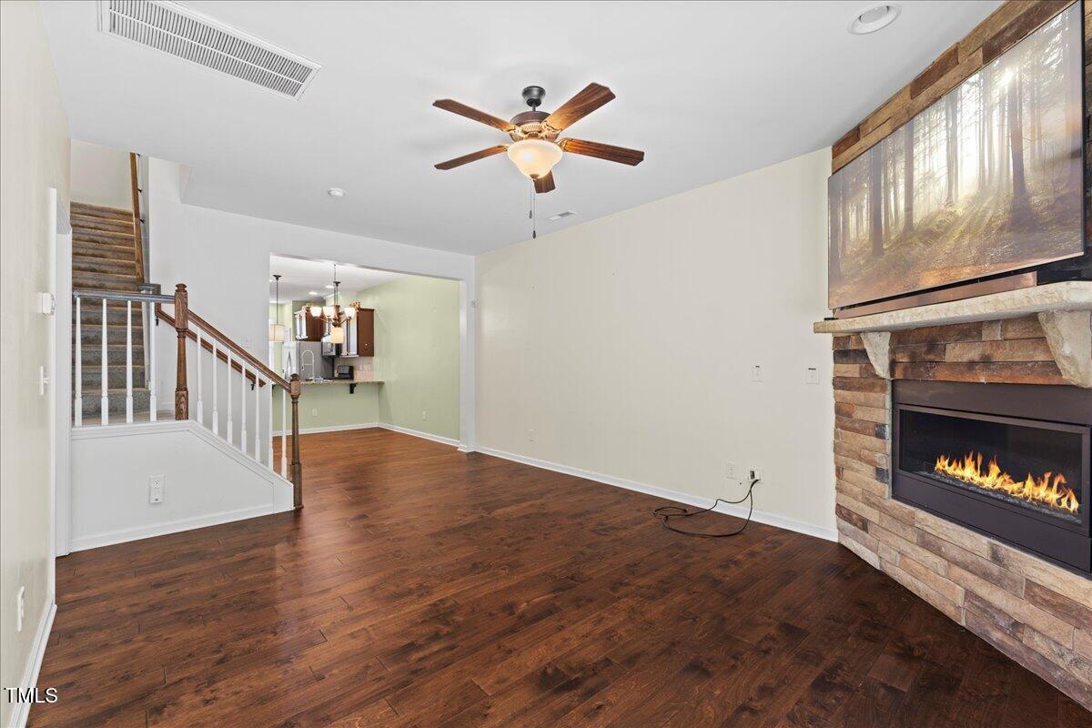 106 Churment Court Durham, NC 27703 - Photo 19 of 50 a view of an empty room with wooden floor a ceiling fan and a window