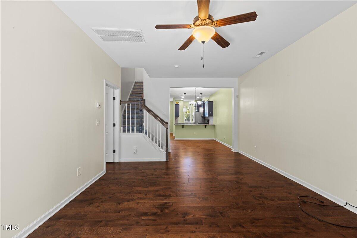 106 Churment Court Durham, NC 27703 - Photo 20 of 50 an empty room with wooden floor ceiling fan and stairs