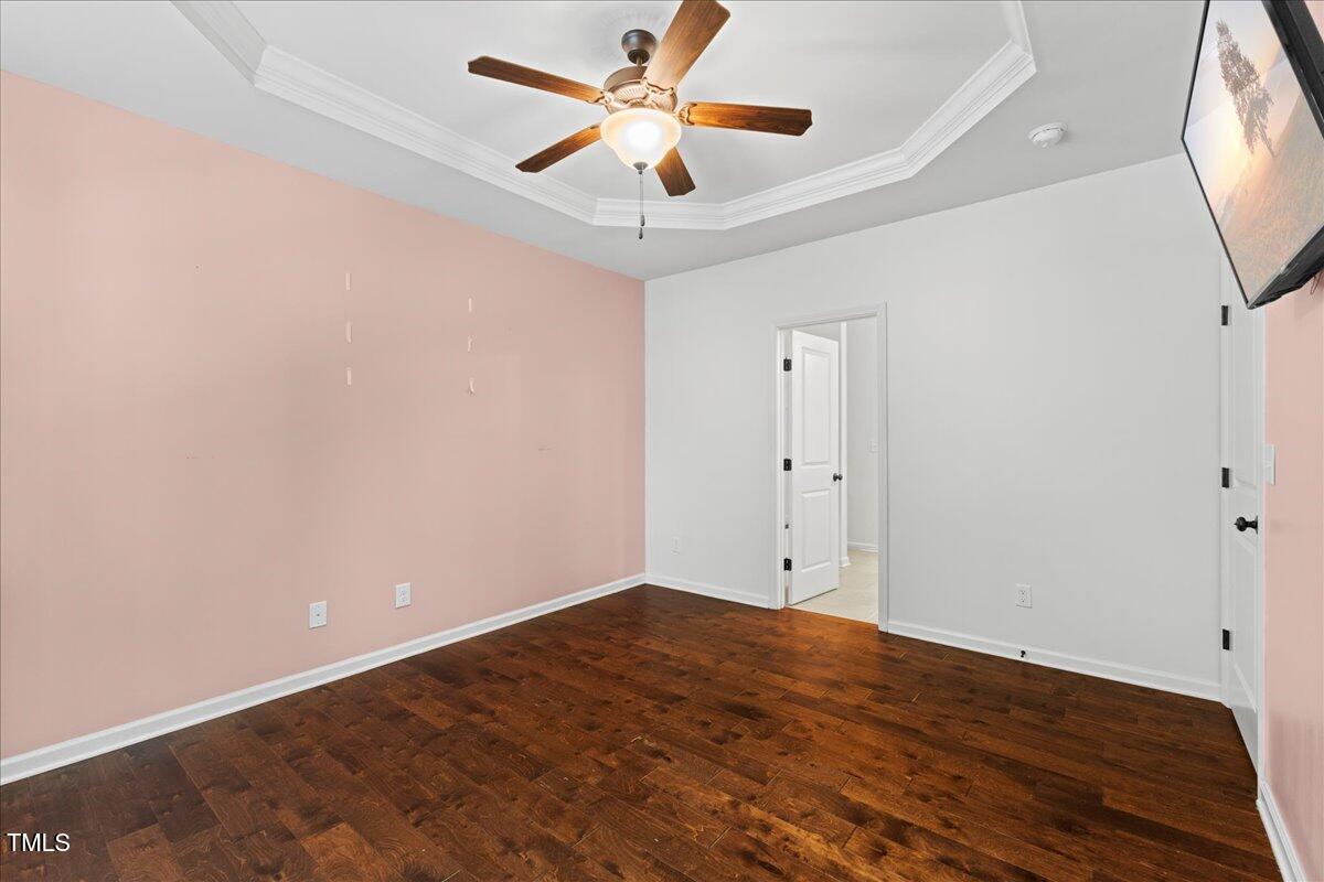 106 Churment Court Durham, NC 27703 - Photo 22 of 50 an empty room with wooden floor and a ceiling fan