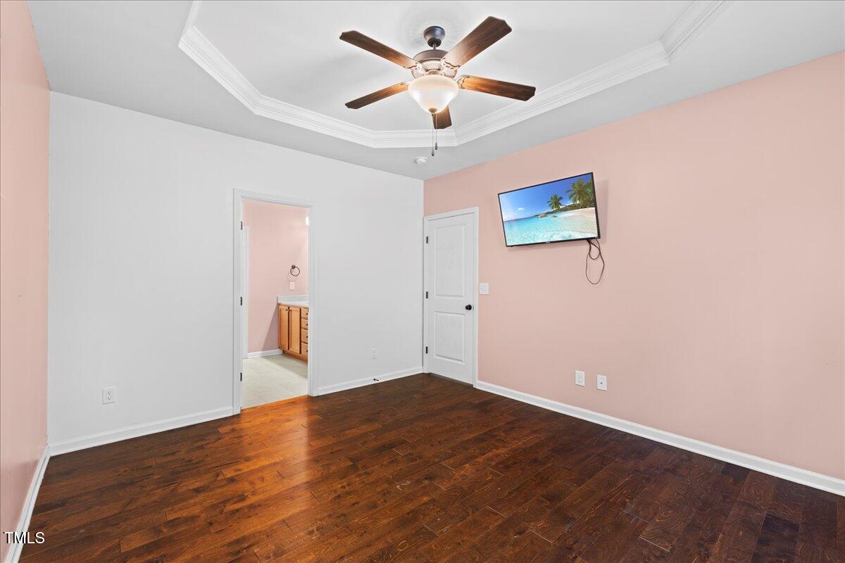 106 Churment Court Durham, NC 27703 - Photo 23 of 50 an empty room with wooden floor and a ceiling fan