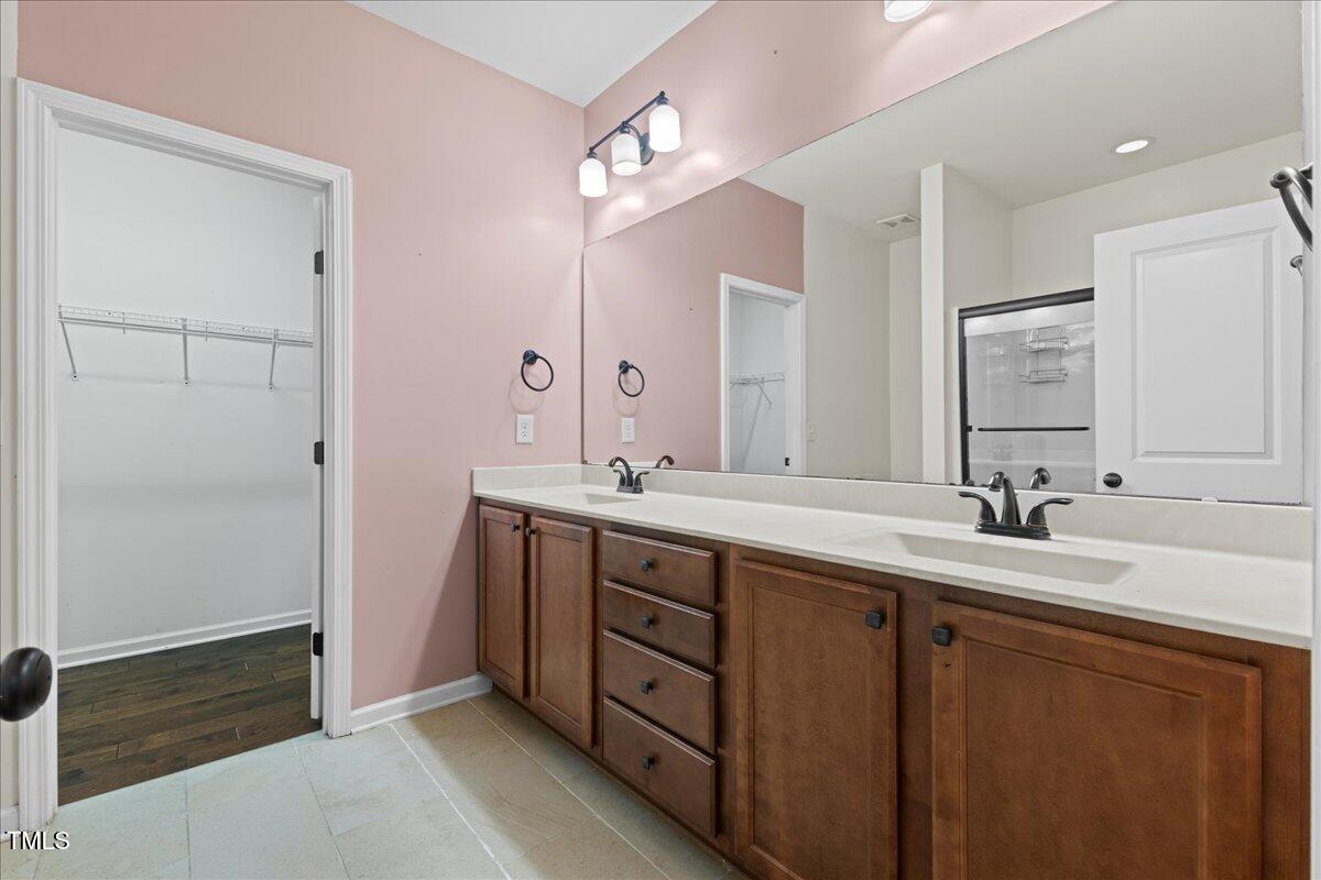 106 Churment Court Durham, NC 27703 - Photo 24 of 50 a bathroom with double sink and a mirror