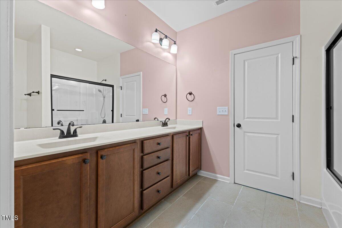 106 Churment Court Durham, NC 27703 - Photo 25 of 50 a bathroom with a double vanity sink mirror and double