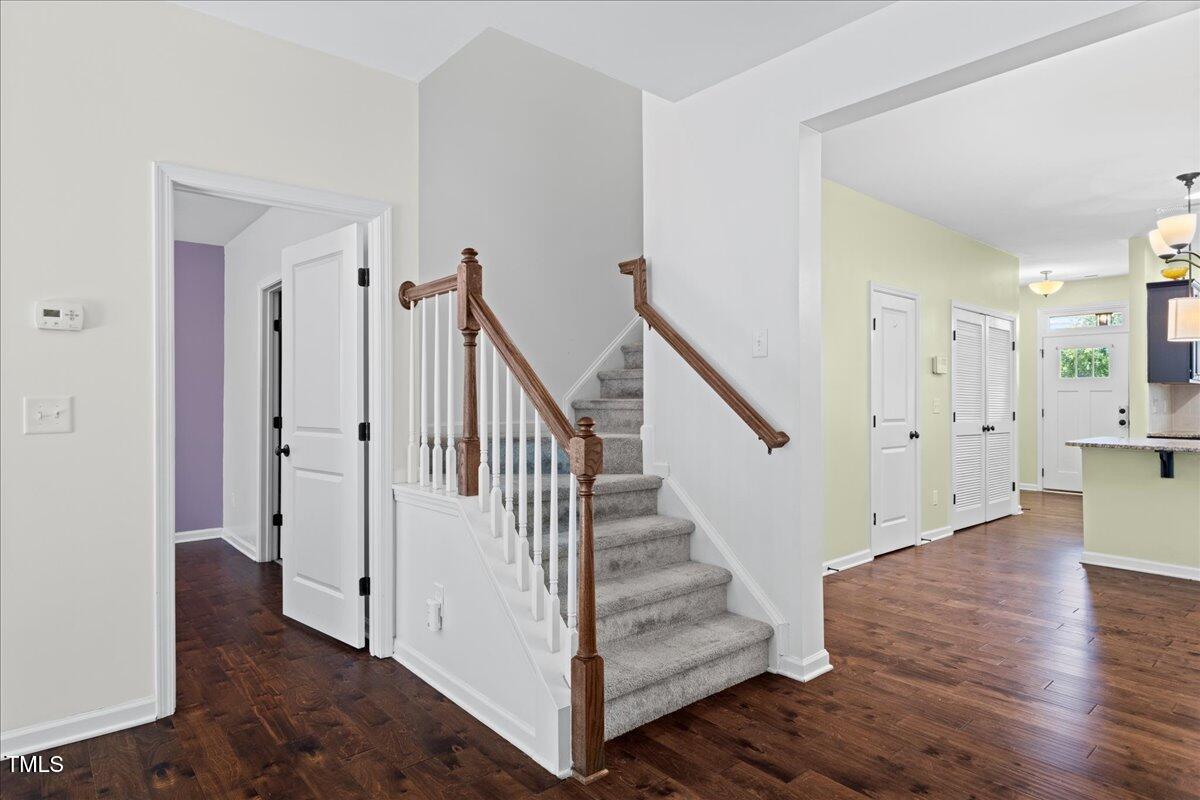 106 Churment Court Durham, NC 27703 - Photo 29 of 50 a view of front door with hallway and wooden floor