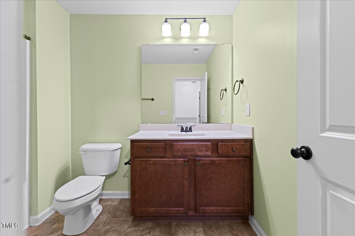 106 Churment Court Durham, NC 27703 - Photo 35 of 50 a bathroom with a toilet a sink and mirror