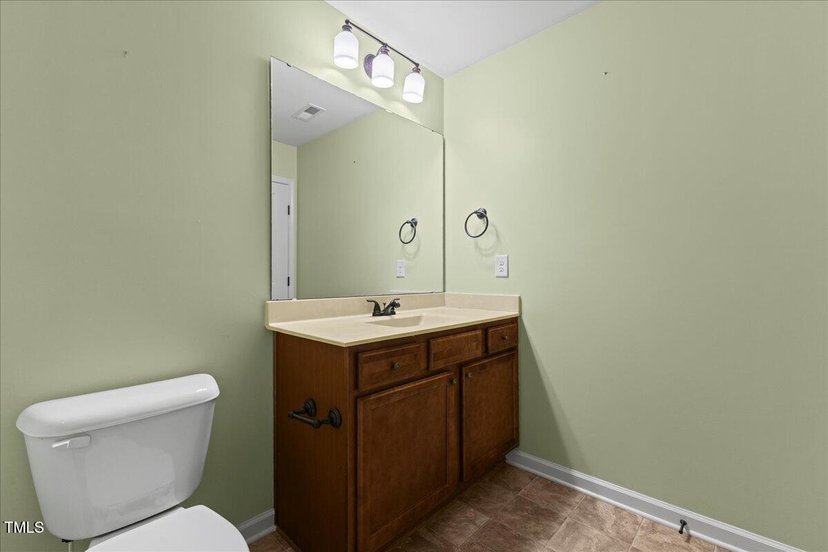 106 Churment Court Durham, NC 27703 - Photo 37 of 50 a bathroom with a toilet sink and mirror
