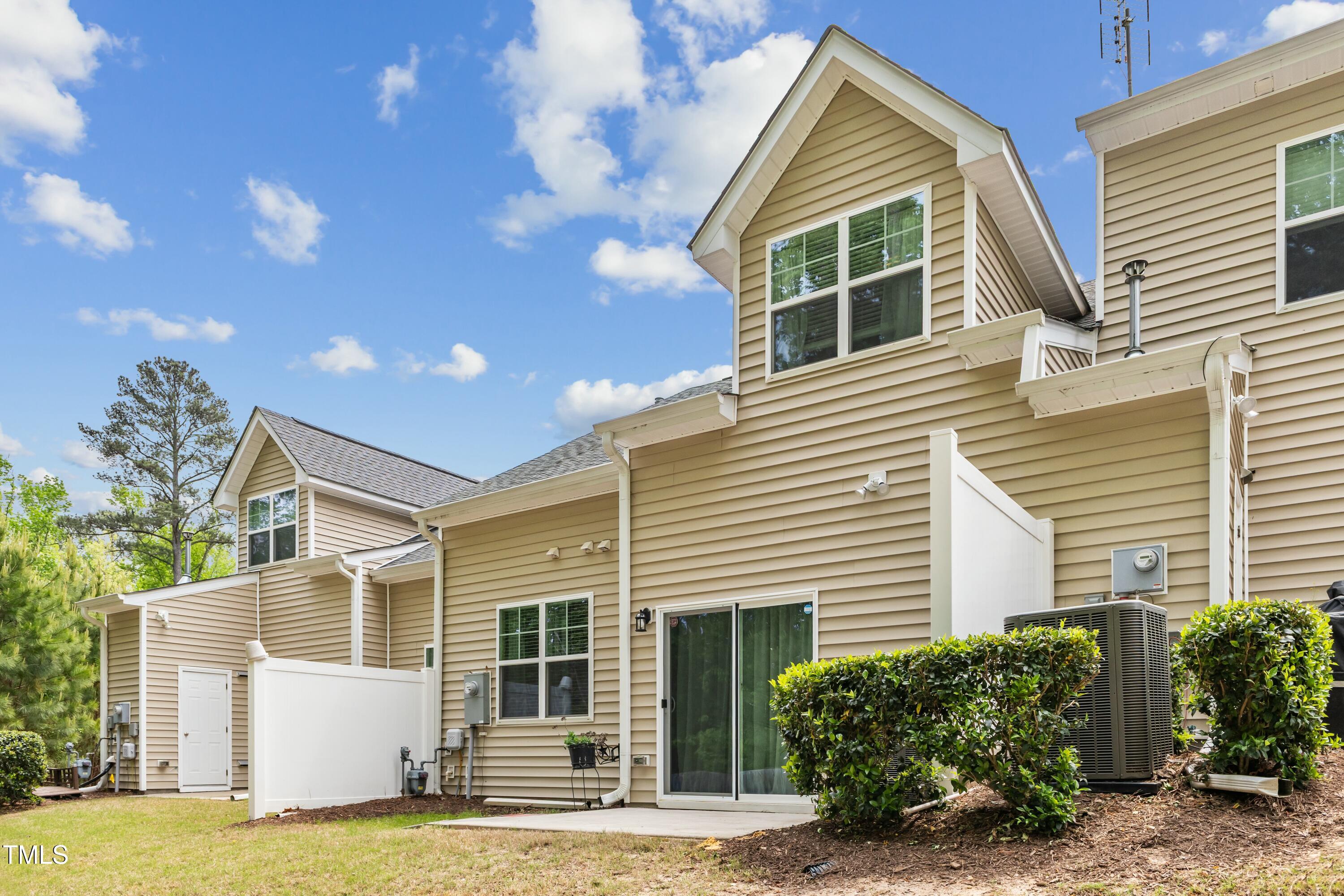 106 Churment Court Durham, NC 27703 - Photo 43 of 50 a view of a house with a yard and potted plants