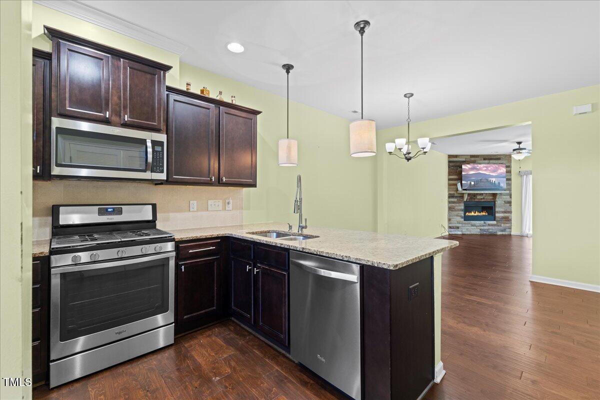 106 Churment Court Durham, NC 27703 - Photo 8 of 50 a kitchen with stainless steel appliances granite countertop a stove a sink and a microwave