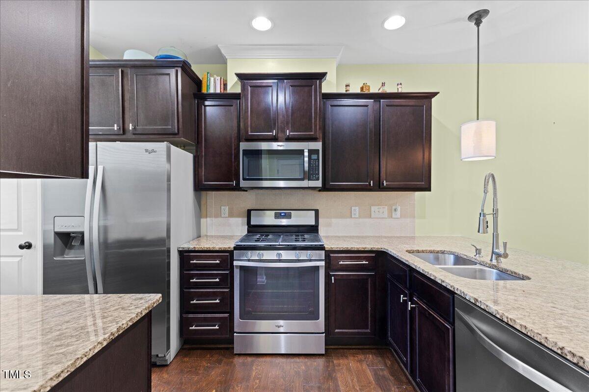 106 Churment Court Durham, NC 27703 - Photo 9 of 50 a kitchen with stainless steel appliances granite countertop a refrigerator and a sink