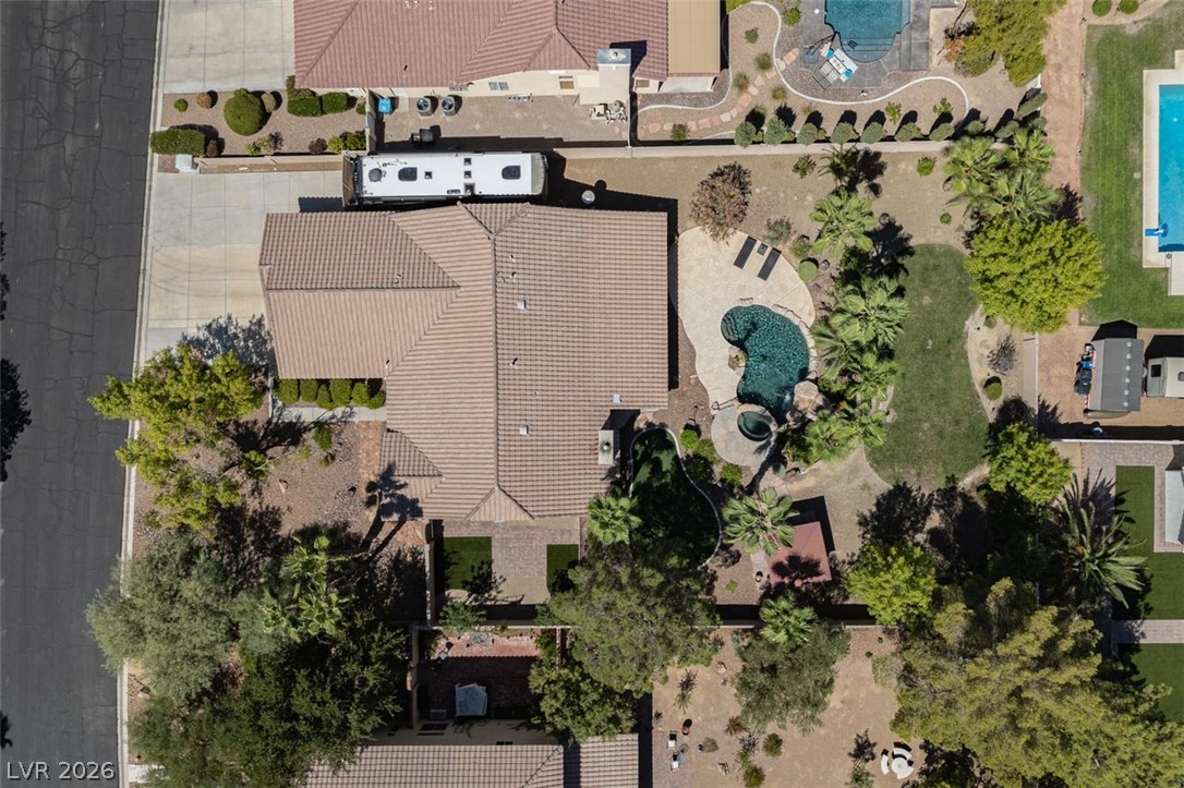 4670 Los Rancheros Avenue Las Vegas, NV 89129 - Photo 4 of 57 An aerial perspective reveals a tiled roofline alongside a private backyard pool and patio and RV Parking