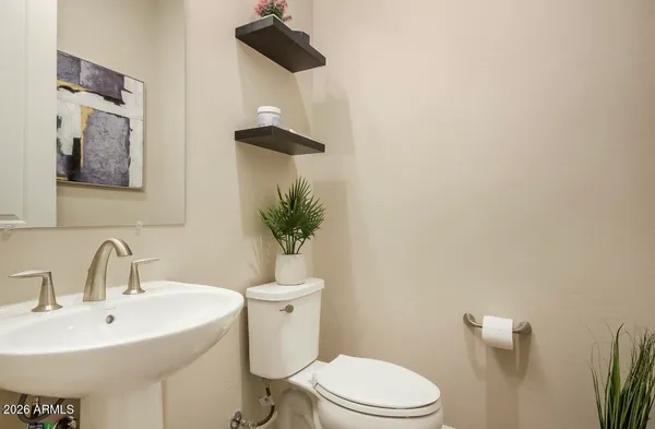 a white toilet sitting next to a bathroom sink