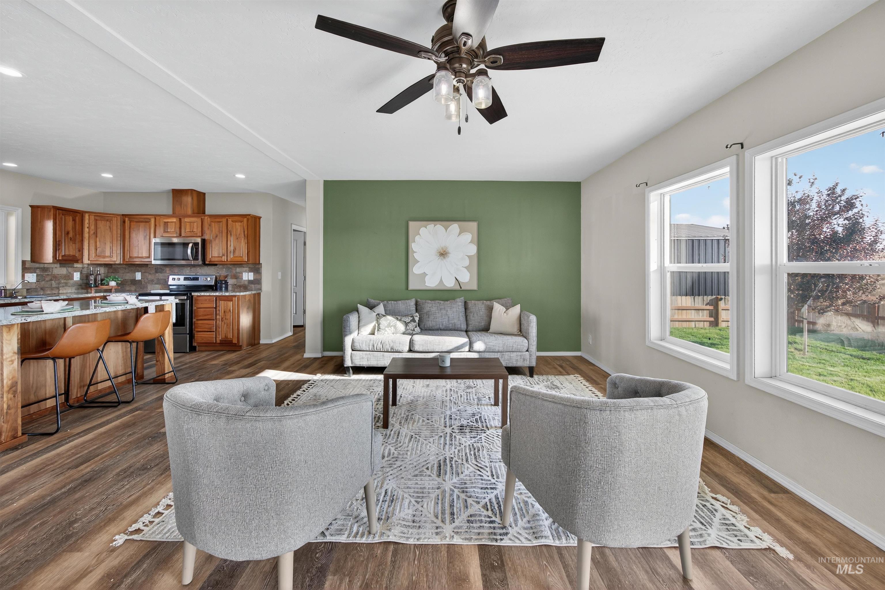 1203 Locker Avenue Parma, ID 83660 - Photo 14 of 49 Living area featuring healthy amount of natural light, dark wood-style flooring, ceiling fan, and recessed lighting