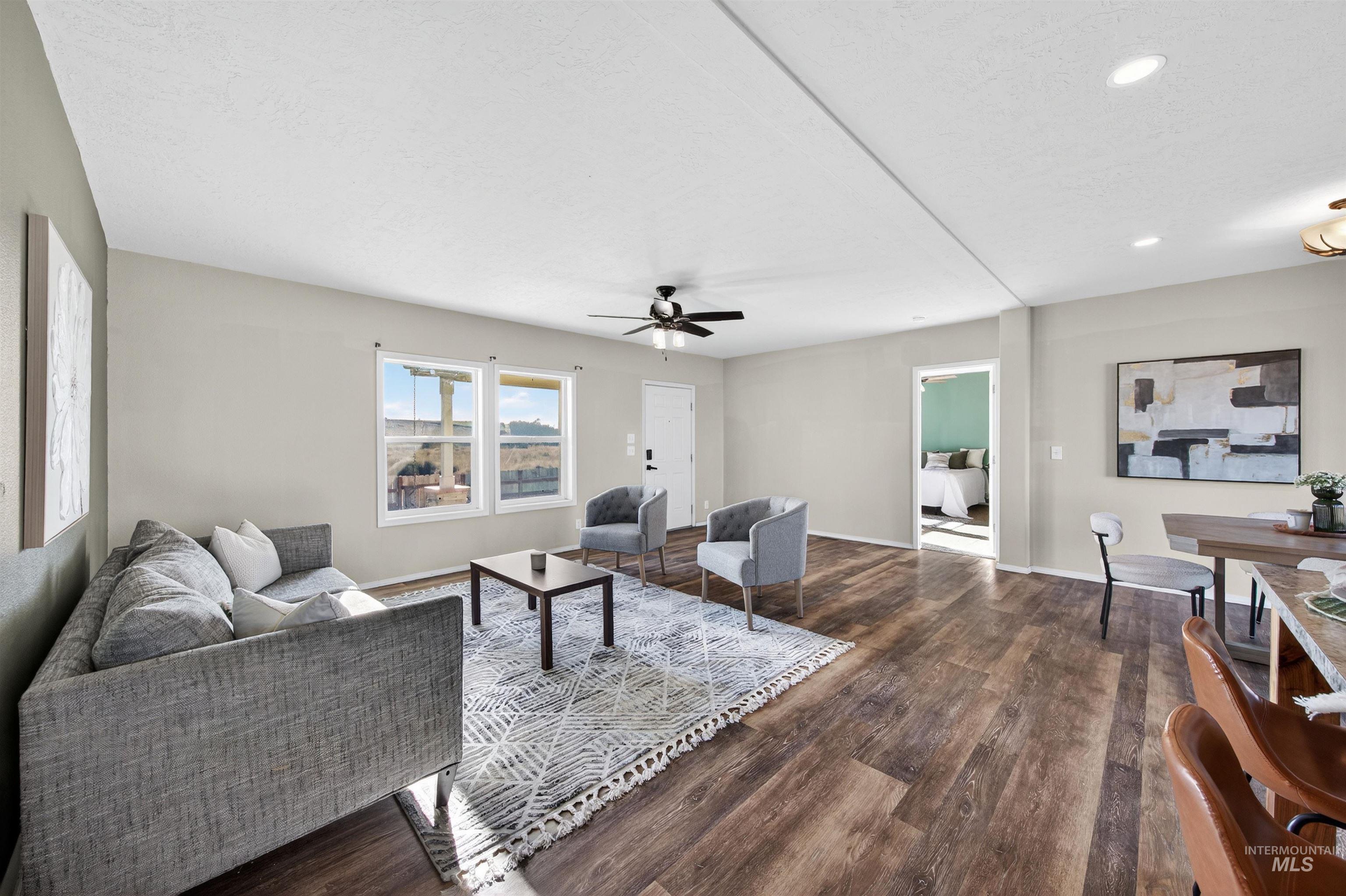 1203 Locker Avenue Parma, ID 83660 - Photo 16 of 49 Living area featuring dark wood-style floors, recessed lighting, and ceiling fan