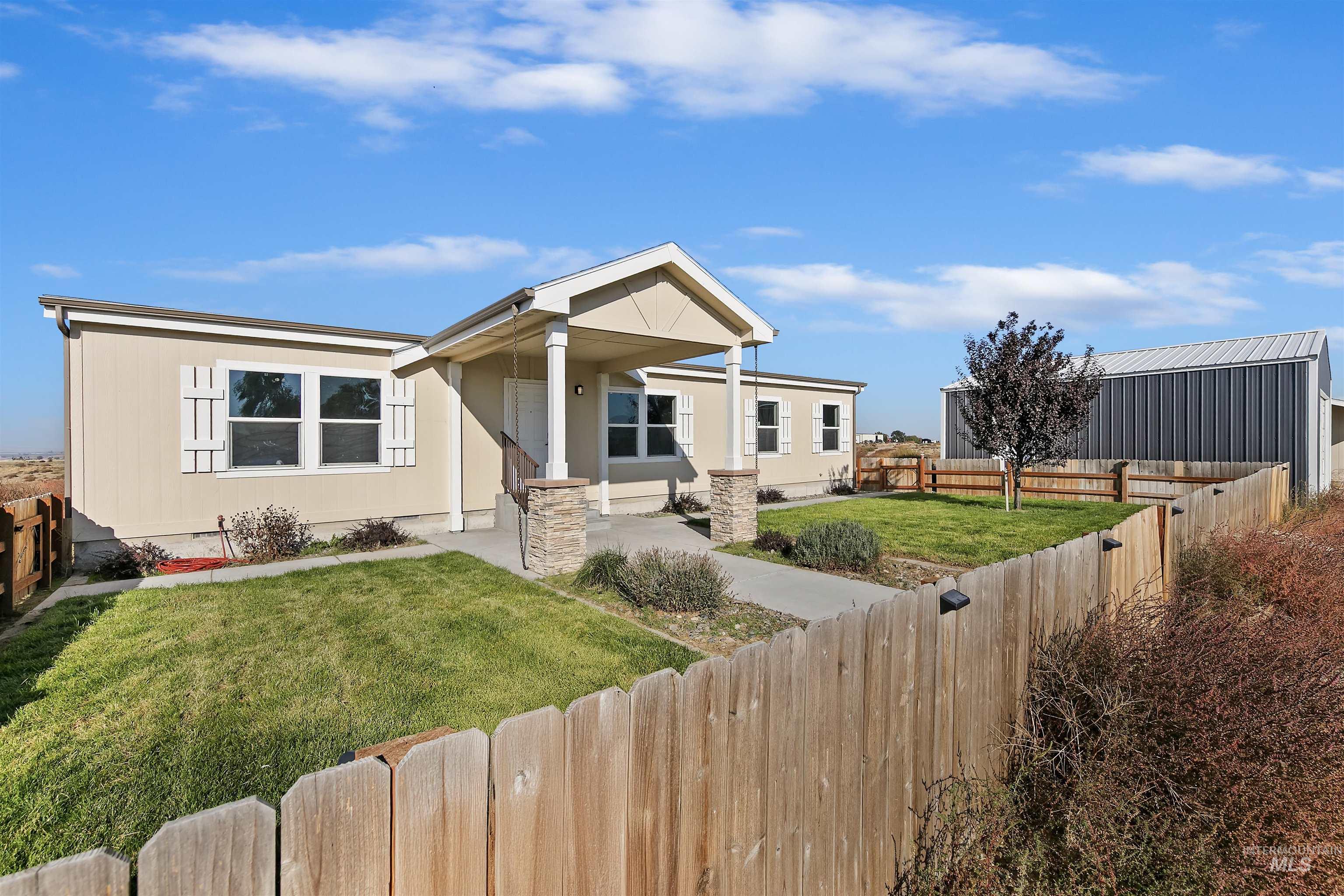 1203 Locker Avenue Parma, ID 83660 - Photo 2 of 49 View of front facade featuring a fenced backyard