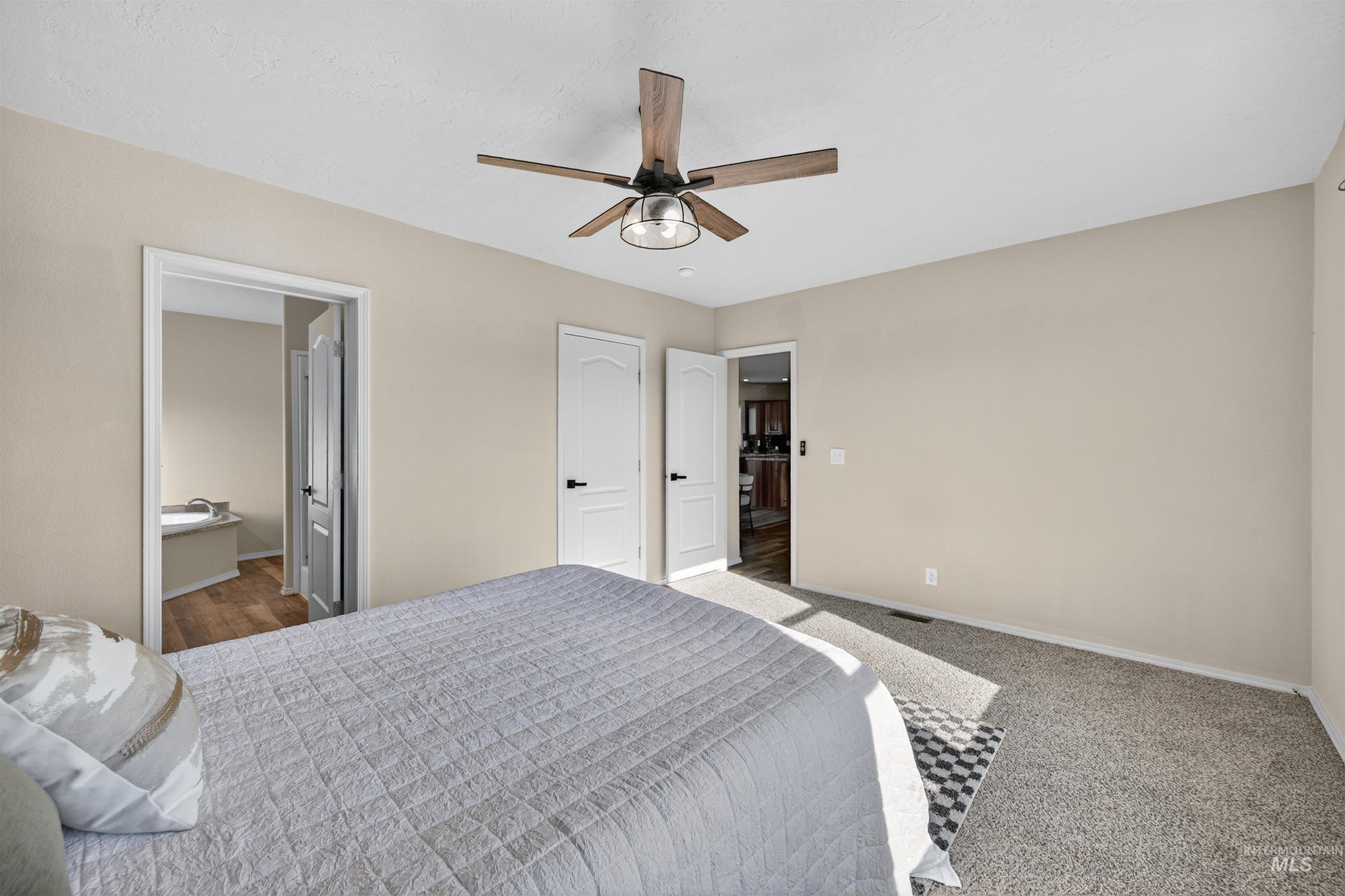 1203 Locker Avenue Parma, ID 83660 - Photo 22 of 49 Carpeted bedroom featuring ceiling fan and connected bathroom