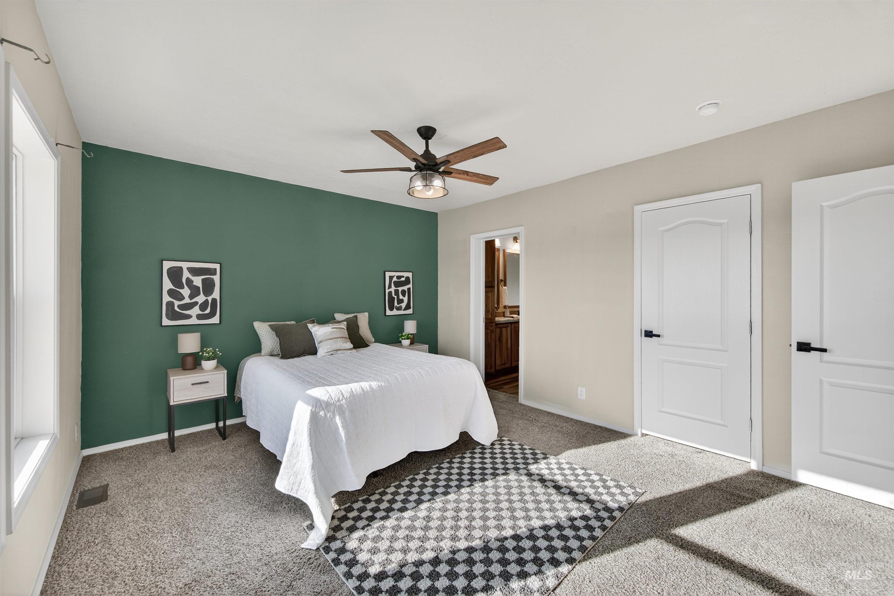 1203 Locker Avenue Parma, ID 83660 - Photo 22 of 49 Bedroom with carpet floors, ensuite bath, and a ceiling fan
