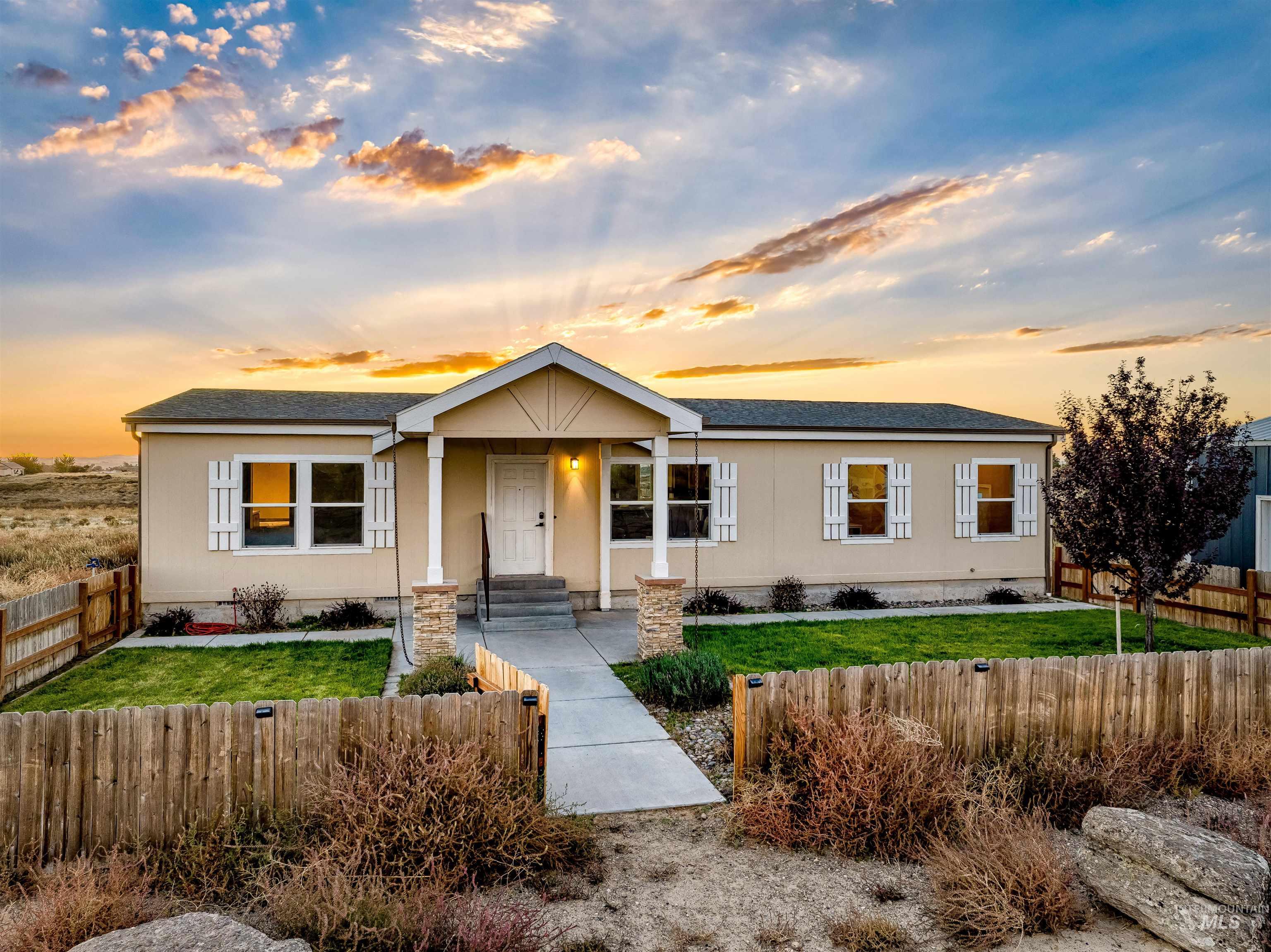 1203 Locker Avenue Parma, ID 83660 - Photo 3 of 49 View of front of house featuring a fenced front yard and a shingled roof