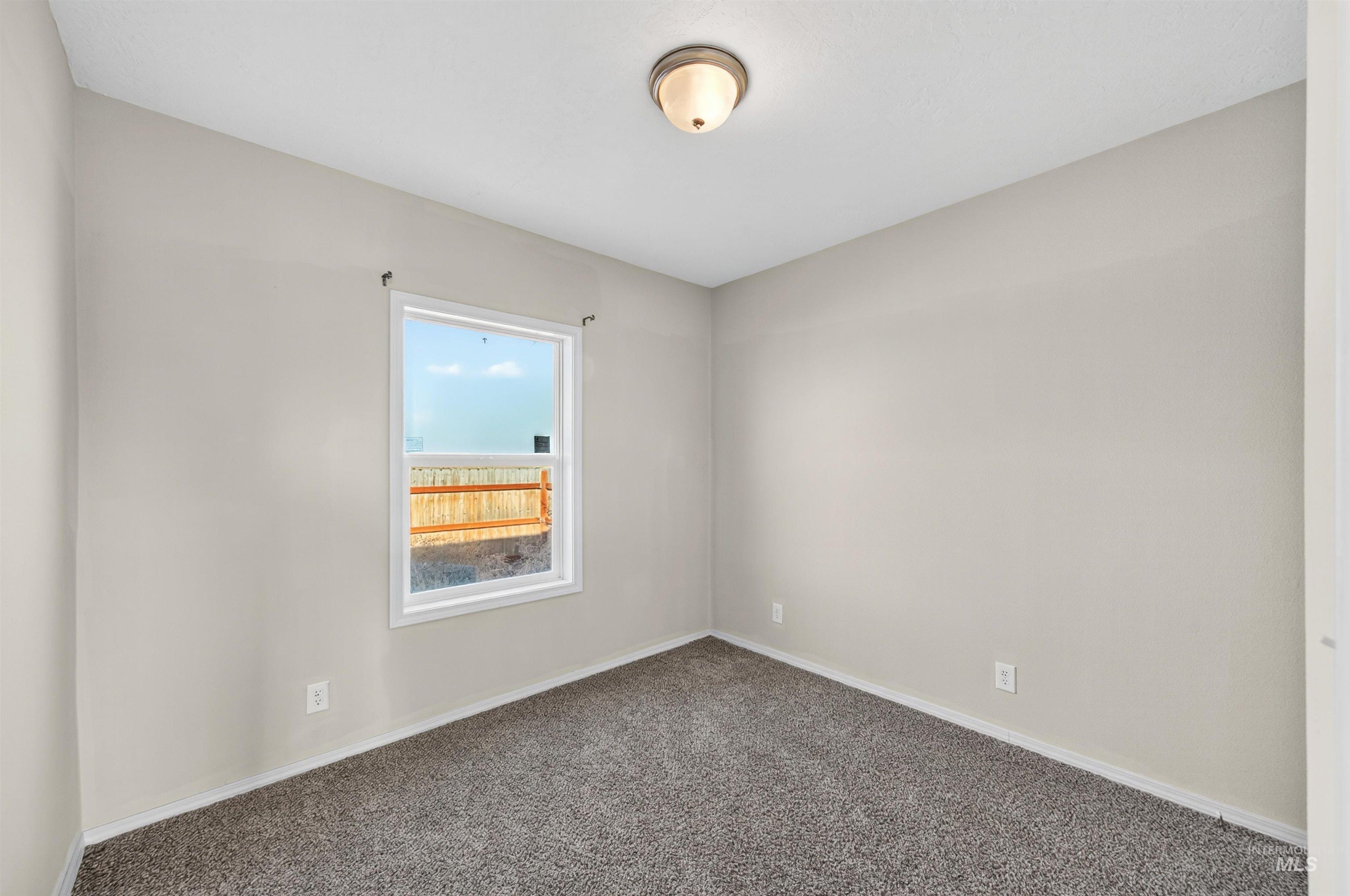 1203 Locker Avenue Parma, ID 83660 - Photo 30 of 49 Carpeted empty room featuring baseboards