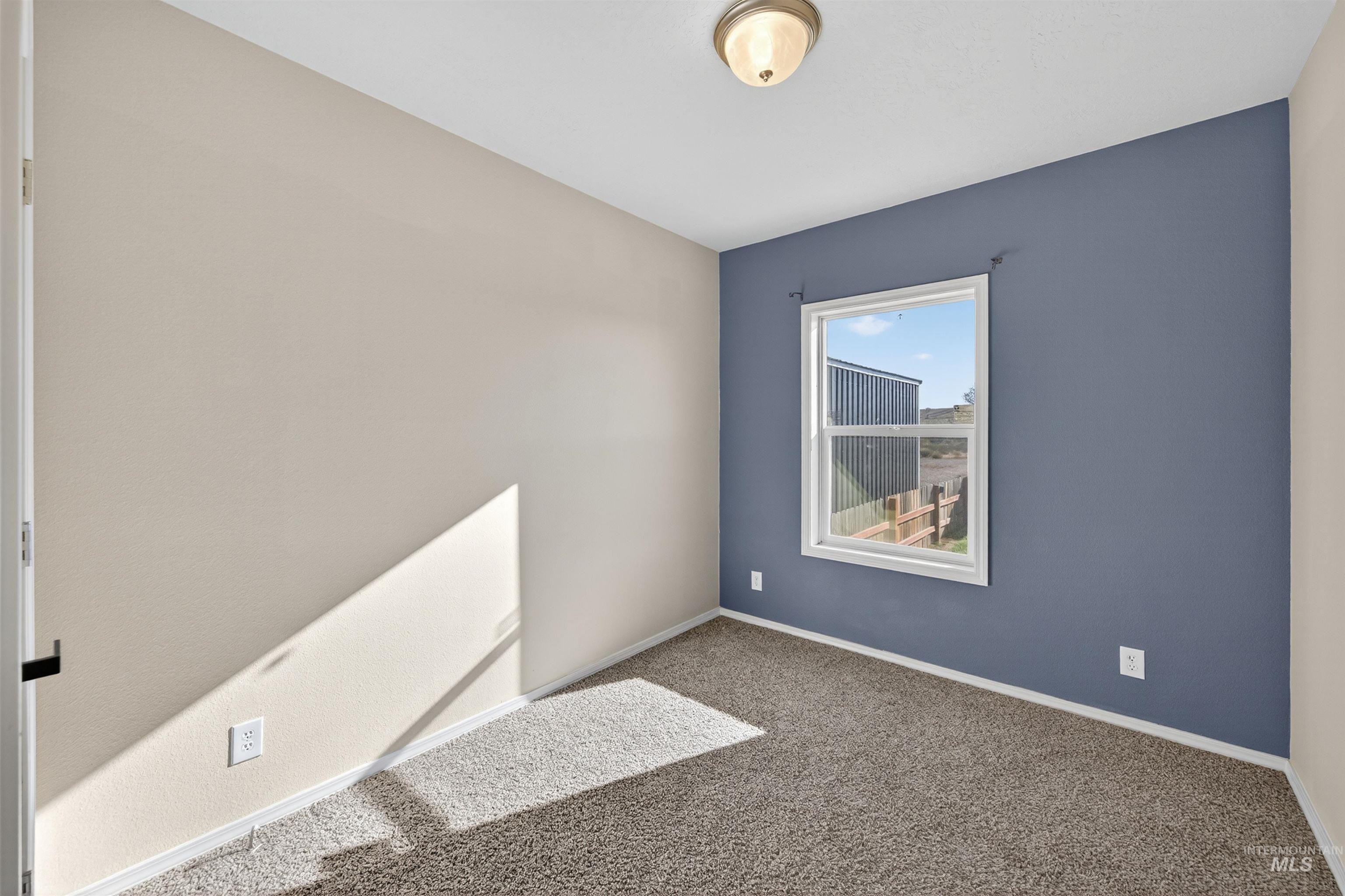 1203 Locker Avenue Parma, ID 83660 - Photo 33 of 49 Empty room with carpet and baseboards