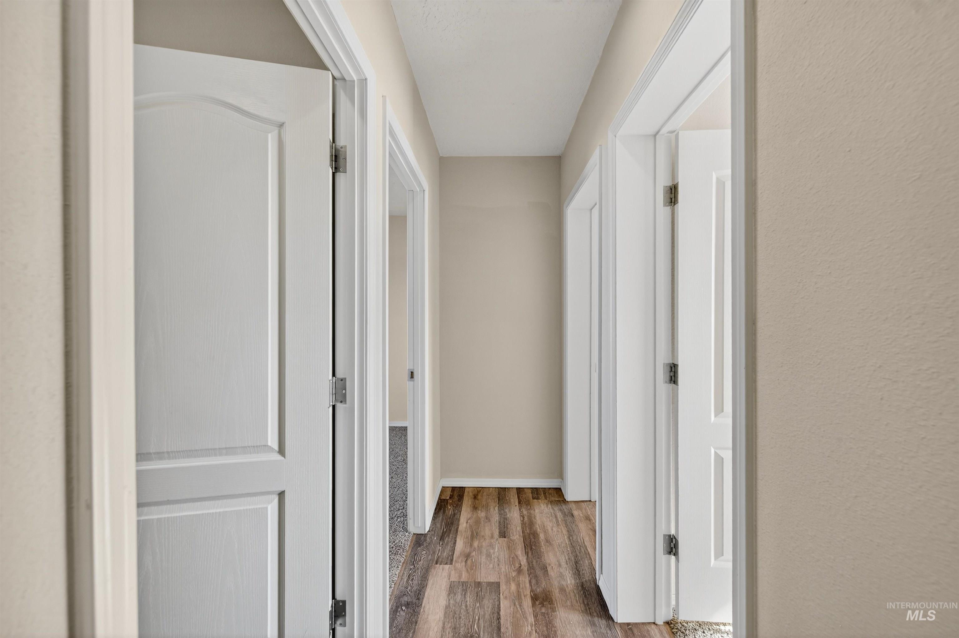 1203 Locker Avenue Parma, ID 83660 - Photo 34 of 49 Corridor with dark wood-type flooring and baseboards