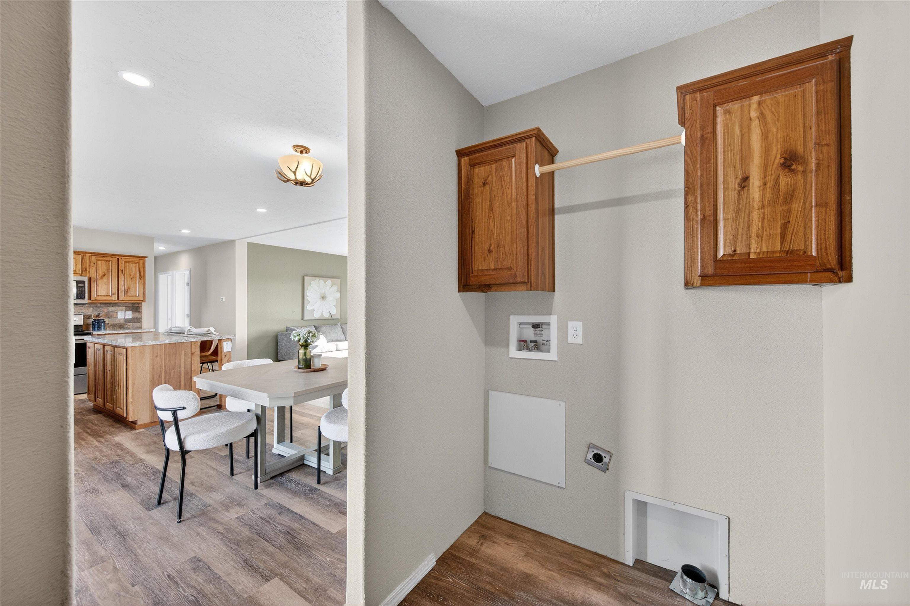 1203 Locker Avenue Parma, ID 83660 - Photo 35 of 49 Washroom featuring recessed lighting, dark wood-style floors, hookup for a washing machine, and cabinet space