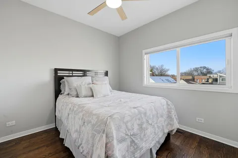 a bedroom with a bed and a painting on the wall