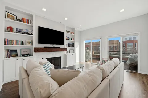 a living room with furniture a fireplace and a flat screen tv