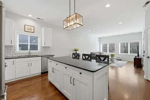 a kitchen with center island and windows