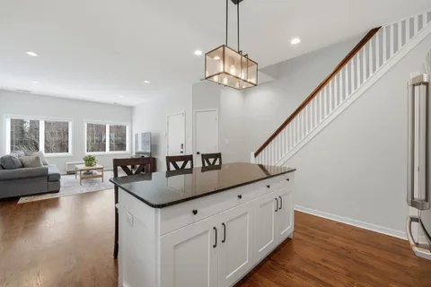 a kitchen with counter top space and wooden floor