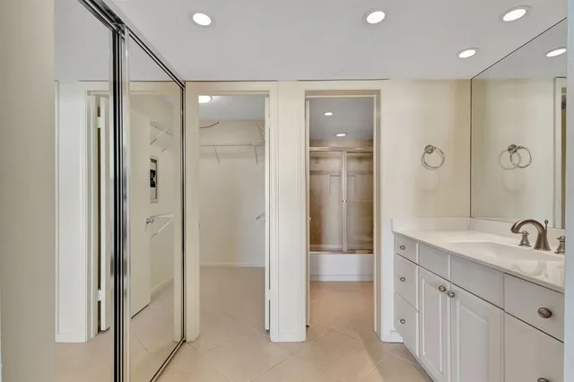 a bathroom with a double vanity sink mirror and shower