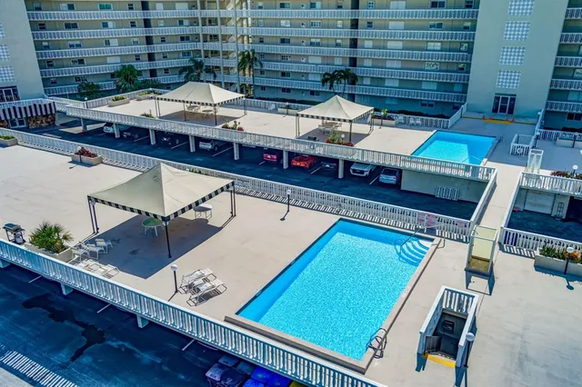 a view of a balcony with two chairs and a potted plant