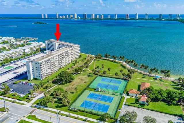 a kitchen with a refrigerator and white cabinets