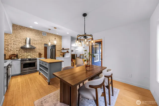 a view of a kitchen with a table and chairs